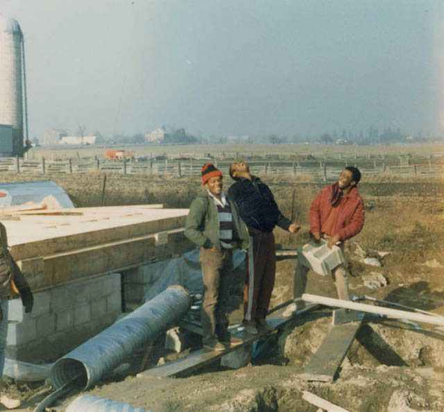 People standing near construction materials