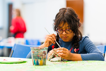 A young girl making crafts