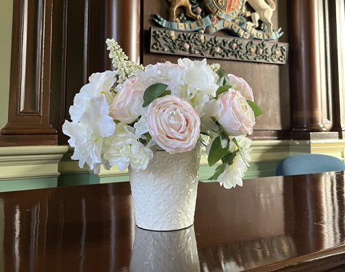 flower resting on a pillar in Council Chambers