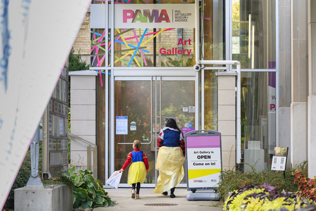 guests entering PAMA in their halloween costumes