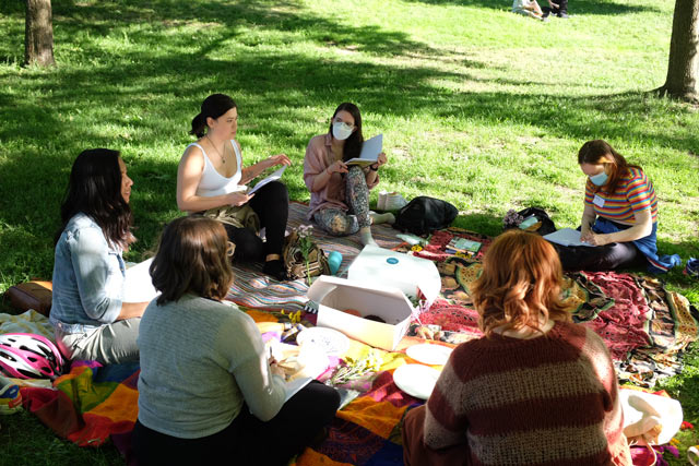 group of people outside sitting on the lawn outdoors