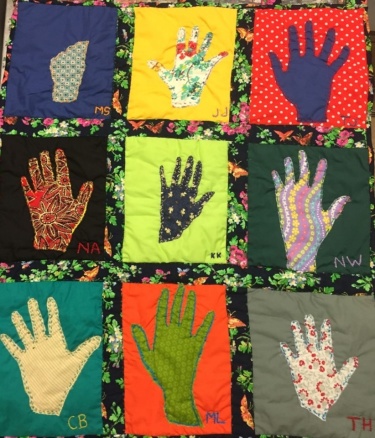 Quilt comprised of depictions of hands