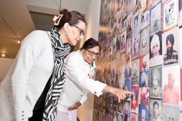 Women looking at the Sikh Heritage Month exhibit