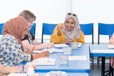 adults painting at workshop