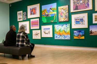 couple gazing at art display