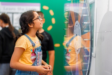 A girl looking at a Spin the wheel game