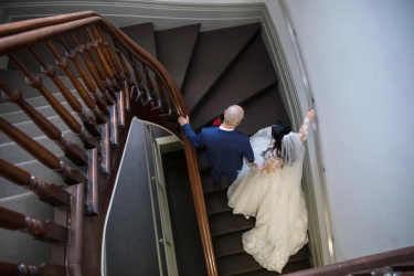 bride and groom walking up stairs